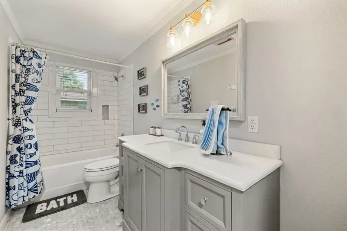 Bright and airy bathroom with plenty of counter space and stylish decor.