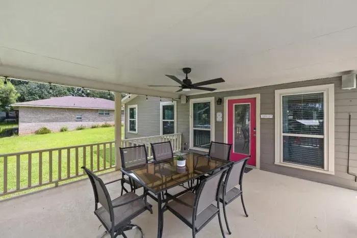 Inviting patio with plenty of seating and beautiful greenery, creating a serene outdoor retreat.