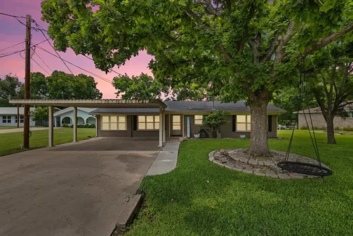 Charming exterior with a welcoming front porch and beautifully landscaped yard.