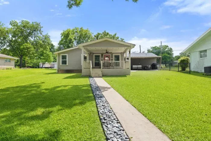 Well-maintained backyard with a variety of trees and shrubs for a natural, private setting.