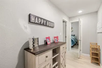 Step into a welcoming hallway that connects the different areas of the home. The spacious corridor is filled with natural light, offering easy access to the bedrooms, living spaces, and adding a sense of flow to the layout.
