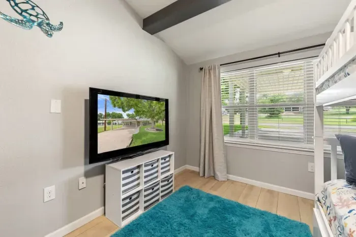 Enjoy family evenings with a collection of toys and a TV for entertainment. This space is perfect for kids to play while the whole family can relax, watch movies, and enjoy quality time together.