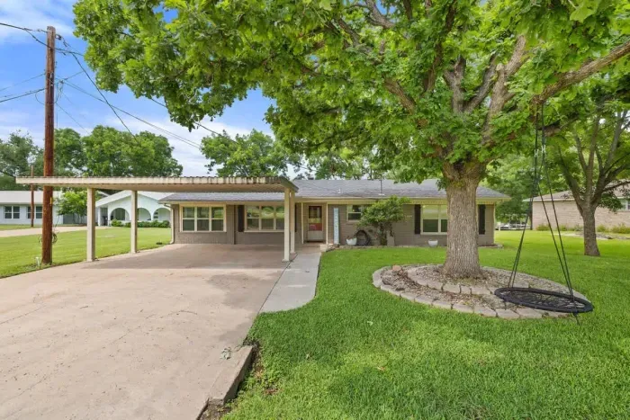 Large backyard with a hammock and shaded areas for ultimate relaxation.