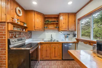 Bright and modern kitchen with stainless steel appliances, perfect for preparing a gourmet meal or quick snacks.