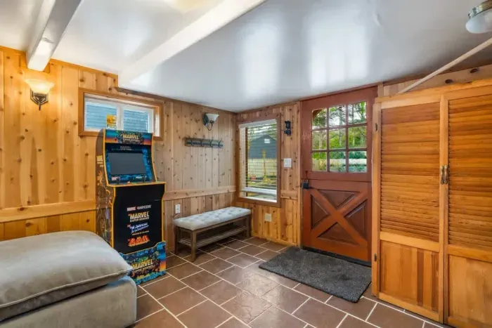 This space features a comfortable daybed that pulls out to a king sized bed, a plush oversized ottoman, and a classic Marvel arcade game for some nostalgic fun.