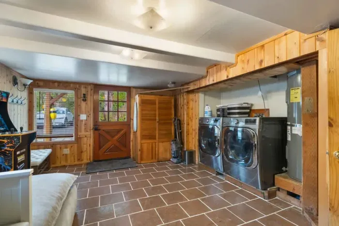 Spacious laundry area featuring a washer, dryer, and ample storage for all your essentials.