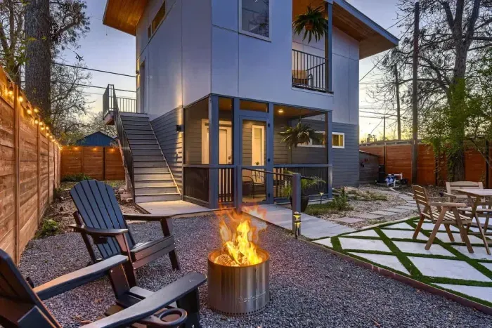 Private fenced backyard with fire pit and outdoor seating, perfect for relaxing evenings in Austin.
