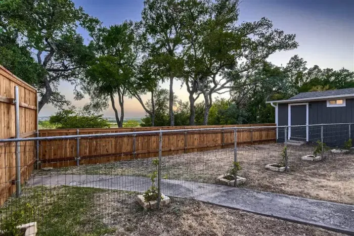 Spacious backyard with a lush lawn, perfect for outdoor games, relaxation, and barbecues.