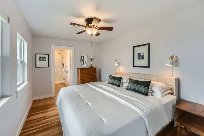 Relax in a spacious bedroom featuring a king-size bed, modern décor, and an en-suite bathroom for added privacy.