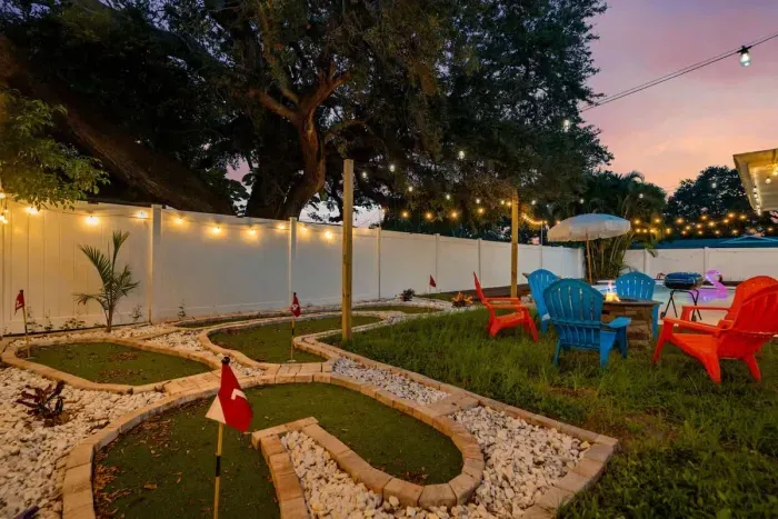 Family-friendly backyard with a play area, plenty of green space, and outdoor seating.