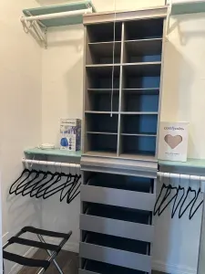 Well-lit laundry room with ample shelving, making it easy to organize laundry supplies and keep everything neat.