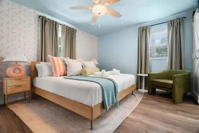 Bright and cheerful bedroom with a large bed and plenty of natural light.