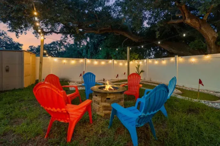 Private backyard oasis featuring a large deck, comfy seating, and a fire pit for cozy evenings.