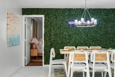 Spacious dining room with a statement chandelier and a table set for entertaining.