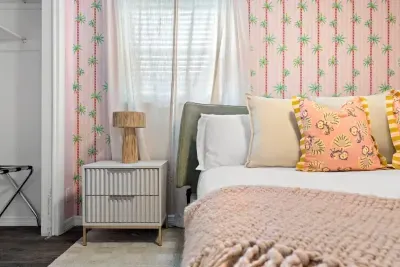 Romantic bedroom with elegant lighting and soft, neutral tones.