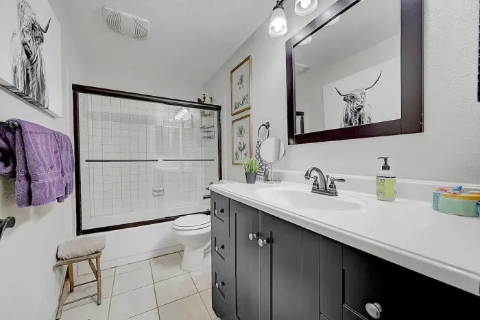Modern bathroom with walk-in shower, stylish tile work, and all essentials for your stay.