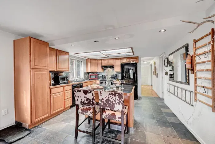 Spacious, fully equipped kitchen with stainless steel appliances and open layout, great for home-cooked meals.