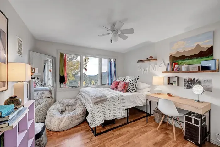 Light-filled second bedroom with comfortable beds and mountain-inspired touches.