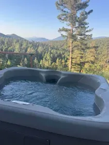 Enjoy your morning coffee or evening wine from the outdoor hot tub overlooking the forest and hills.