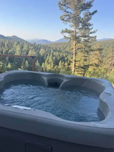 Unwind under the open sky in your private mountain-view hot tub, surrounded by peaceful nature.