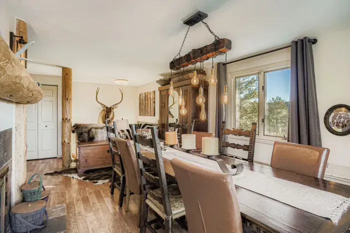 Dining area with wood table and picture-perfect mountain scenery.