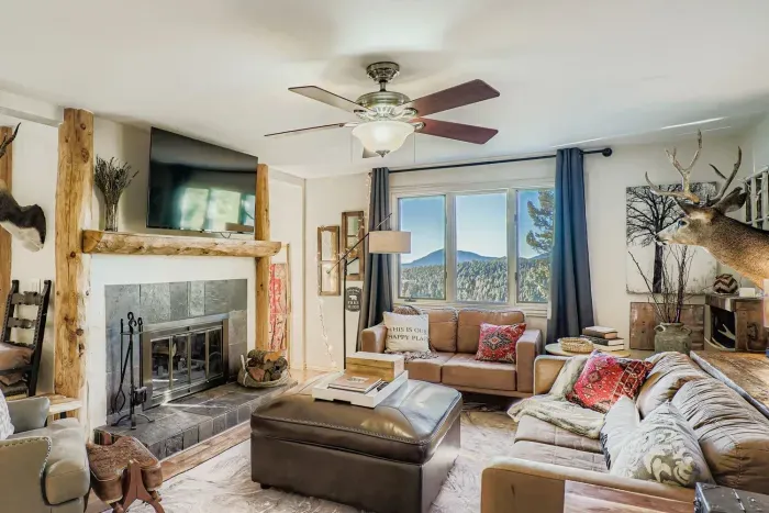 Open-concept living space with rustic beams and mountain views.