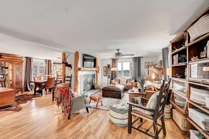 Cozy mountain-view living room with rustic wood accents and plush seating for relaxing after a day of exploring.