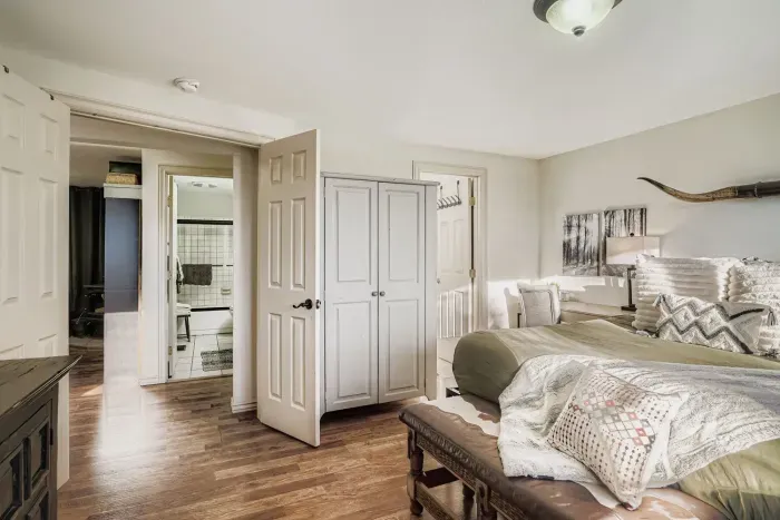 Spacious primary suite with plush bedding and natural light.