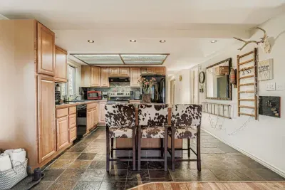Spacious and fully equipped kitchen featuring modern stainless steel appliances, generous counter space, and an open layout that flows seamlessly into the living areas, making it ideal for preparing home cooked meals, hosting family dinners.