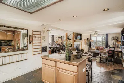 Spacious open kitchen with island seating and rustic charm.