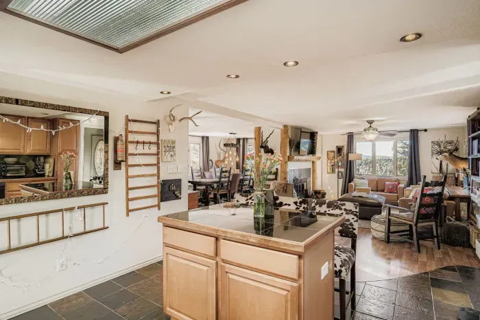 Spacious open kitchen with island seating and rustic charm.