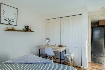 Peaceful master bedroom with soft linens and calming tones.