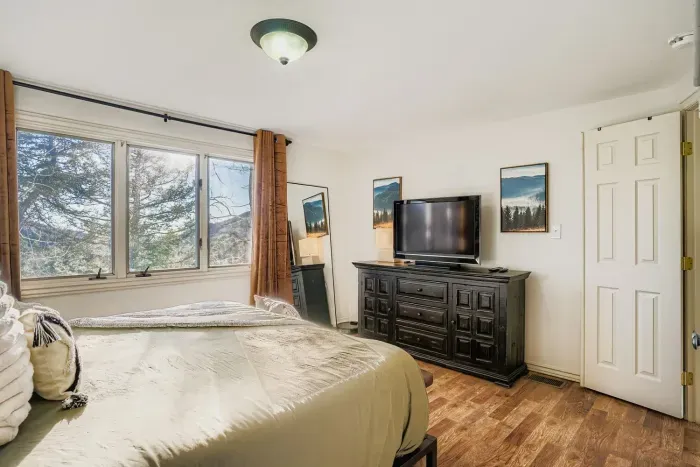 Restful primary suite offering a tranquil mountain escape.