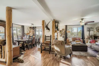 Open-concept living space with rustic beams and mountain views.