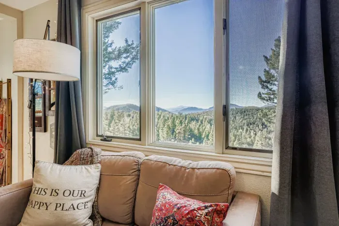 Reading nook with breathtaking views of the Rockies and forested hills.