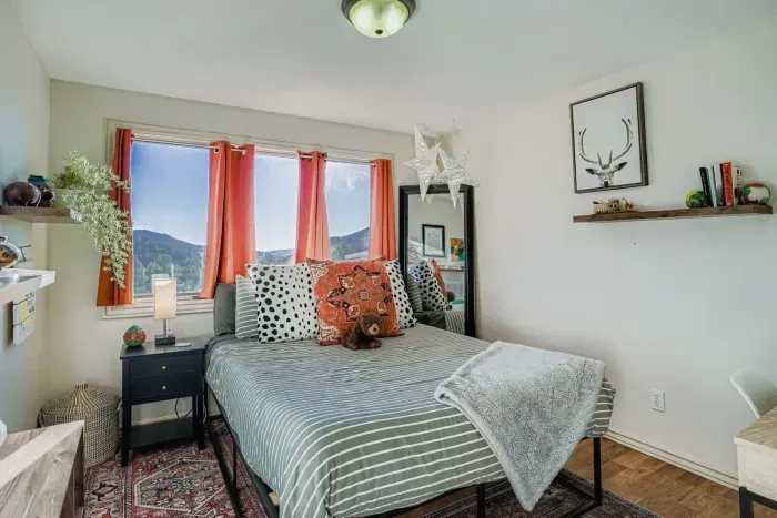 Guest bedroom with queen bed and beautiful window light