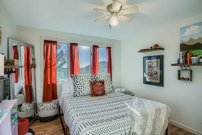 Cozy third bedroom with scenic views and warm décor.
