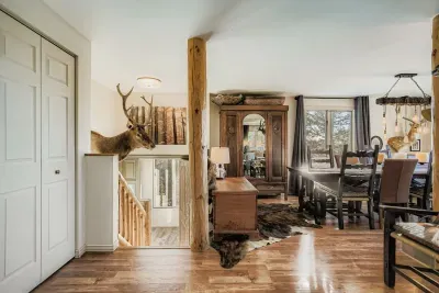 Spacious living area with plush seating and large windows overlooking nature.
