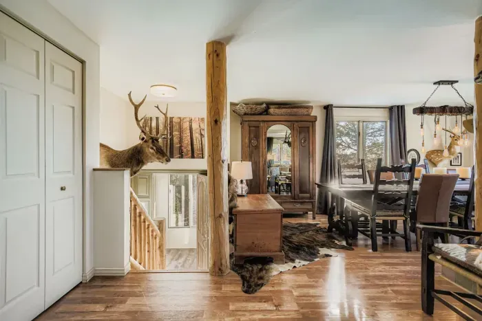 Spacious living area with plush seating and large windows overlooking nature.