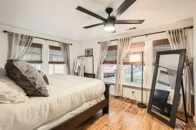 Natural light floods this charming room, complete with a king-size bed and stylish furniture, making it the perfect spot for a peaceful stay.