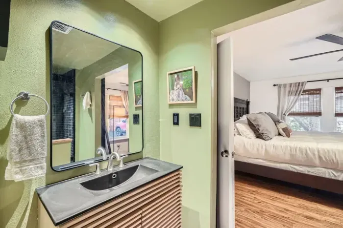 Spacious bathroom with a modern sink and a large mirror for added convenience.