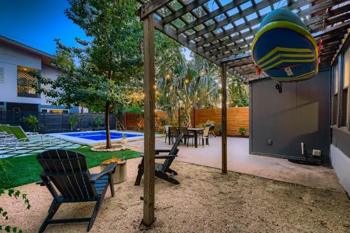 Refreshing pool surrounded by greenery and lounge chairs.