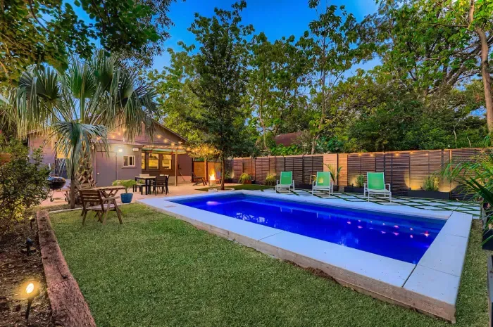The pool lit beautifully in the evening for a private resort feel.