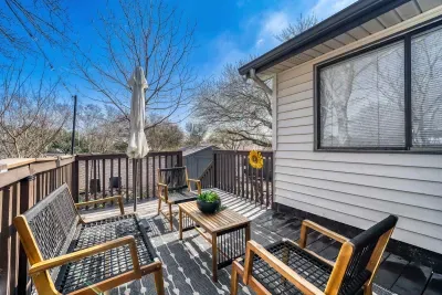 Elevated deck with outdoor seating and umbrella, ideal for morning coffee or sunset unwinding