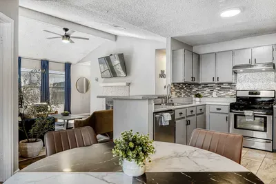 Open dining and kitchen layout with marble table seating, perfect for gathering, cooking, and staying connected