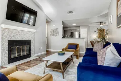 Stylish, airy living space with fireplace centerpiece and inviting layout for connection and comfort