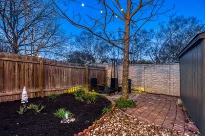 Charming garden corner with pathway, lighting, and private seating nook