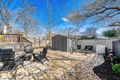 Spacious yard with fire pit and multiple seating areas designed for gathering and connection