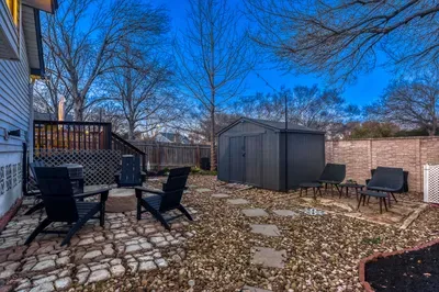 Private backyard with fire pit, lounge seating, and open sky views making it ideal for relaxing or gathering