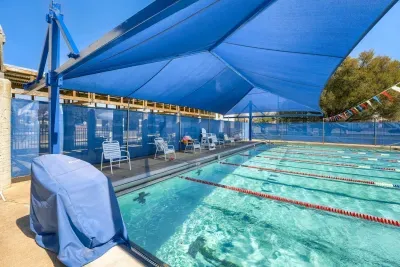 Covered lap pool with shaded lounge area for year-round swimming